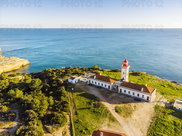 Cliffy coast of Algarve with Alfazinha Lighthouse in Carvoeiro