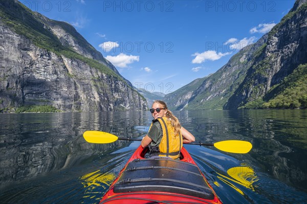 Young woman paddling in a kayak