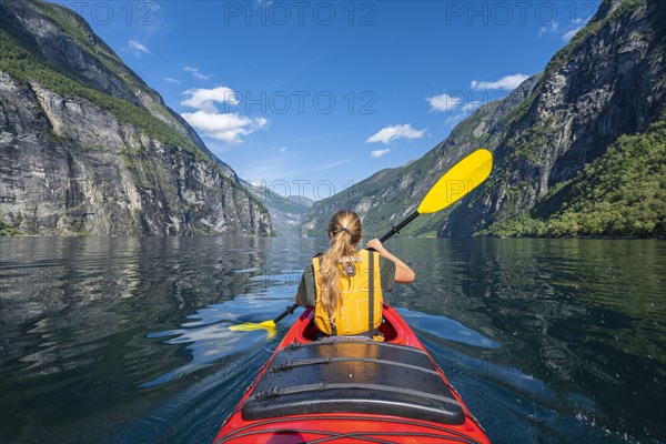Young woman paddling in a kayak