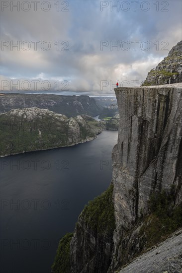 Person standing on steep cliff