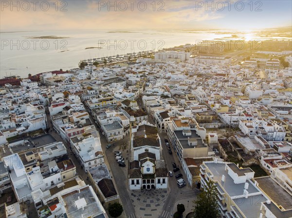 Aerial view of Olhao with a church in the foreground by sunset