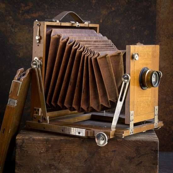 Old camera on brown background