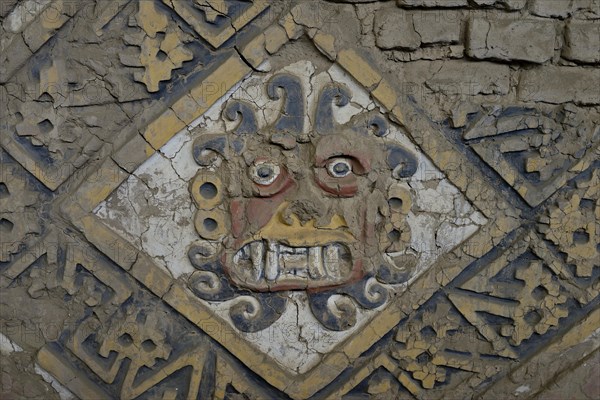 Colourful relief of the Moche culture on adobe walls