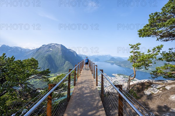 Hiker standing on viewing platform Rampestreken