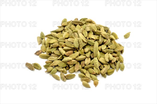 A pile of cardamom pods against a white background