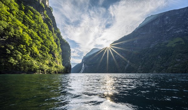 Sun and mountains reflected in the Geirangerfjord