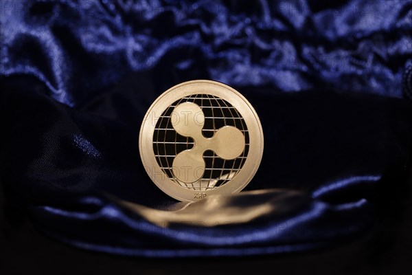 An XRP Ripple on blue velvet