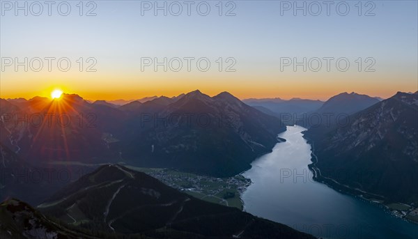 Last rays of sun over mountain landscape at sunset