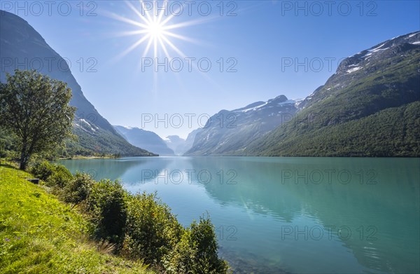 Sun shining at lake Lovatnet and mountains