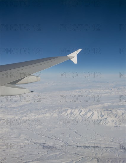 View of mountains and snowy landscape from the airplane