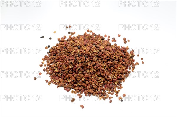 Sichuan peppercorns against a white background