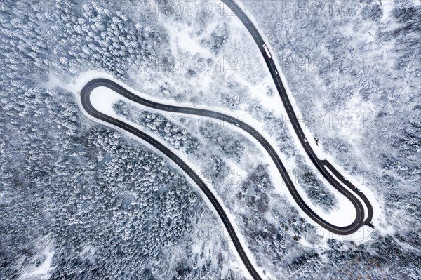 Winter snow road serpentines S-curve curves Lochenpass forest aerial photo way curve