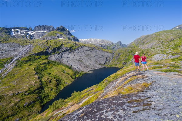 Hikers looking at mountain landscape