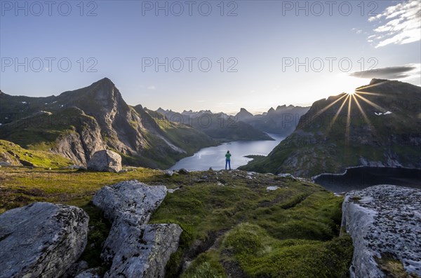 Young woman looking over fjord landscape