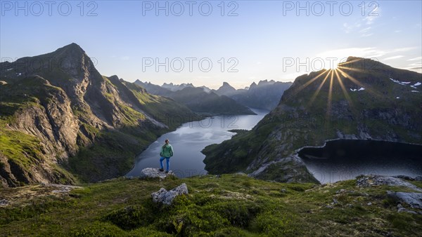 Young woman looking over fjord landscape