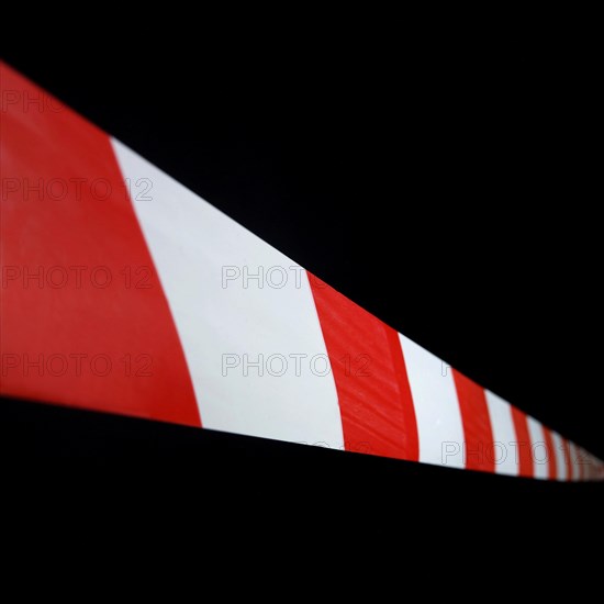 Red and white striped plastic hazard tape