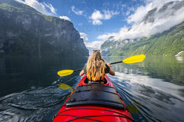 Young woman paddling in a kayak