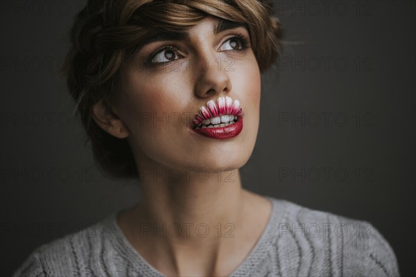 Young woman with flower lips