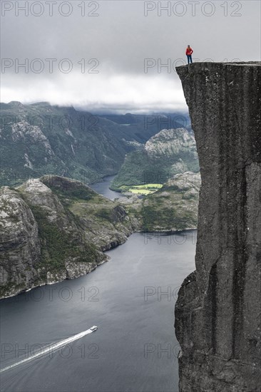 Person standing on steep cliff