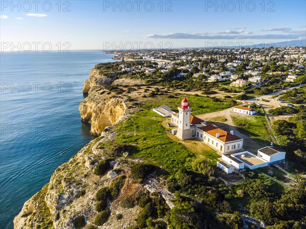 Cliffy coast of Algarve with Alfazinha Lighthouse in Carvoeiro