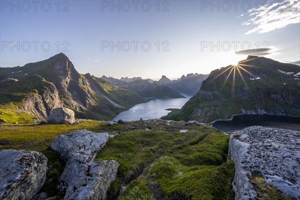 Sun shines over mountain landscape with fjord Forsfjorden and lake Krokvatnet