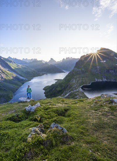 Young woman looking over fjord landscape