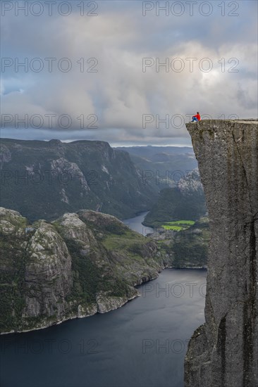 Single person sitting on rock plateau