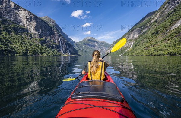 Young woman paddling in a kayak