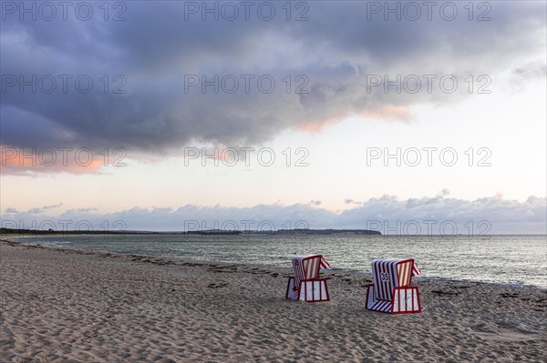 Lonely beach chairs in the morning light at the big beach of Thiessow