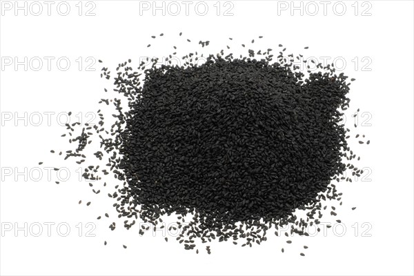 Nigella seeds against a white background