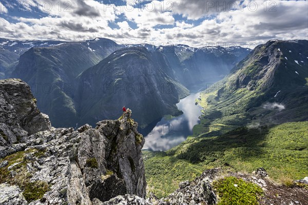 Hiker standing on rocky outcrop