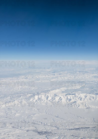 View of mountains and snowy landscape from the airplane