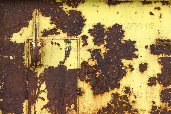 Yellow painted rusty metal plate