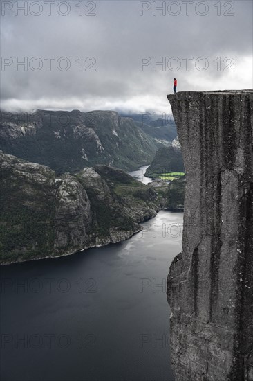 Person standing on steep cliff