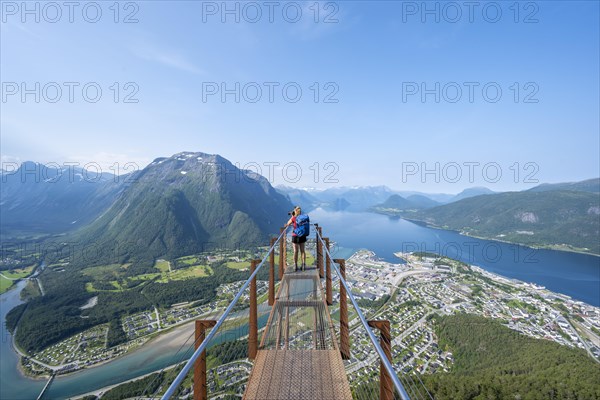 Hiker taking photos on viewing platform Rampestreken