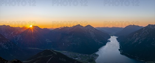 Last rays of sun over mountain landscape at sunset