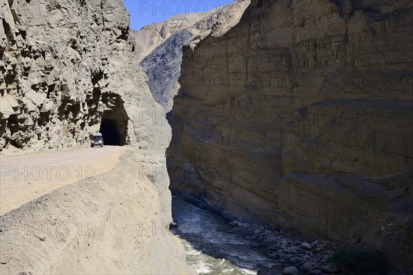 Tunnel with off-road vehicle on the road through the Duck Canyon