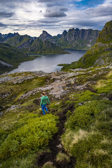 Hiker walks through mountain landscape