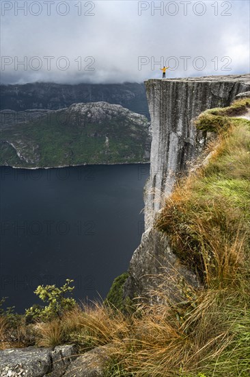 Person standing on steep cliff