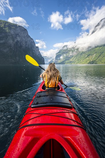 Young woman paddling in a kayak