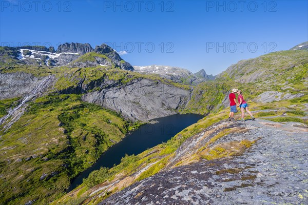 Hikers looking at mountain landscape