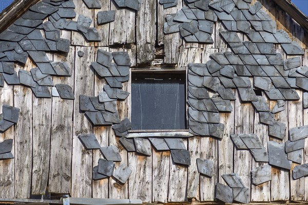 Broken slate facade of an old farmhouse