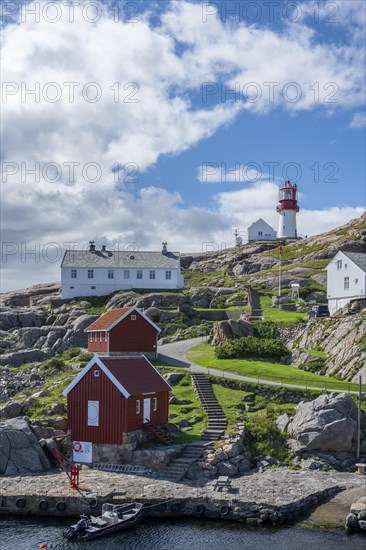 Houses and red and white Lindesnes lighthouse