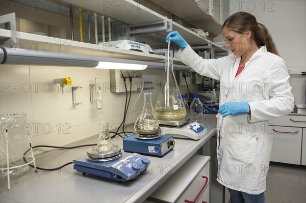 Scientist of biology at stirring devices in the genetic engineering section of the laboratories of the University of Duisburg-Essen