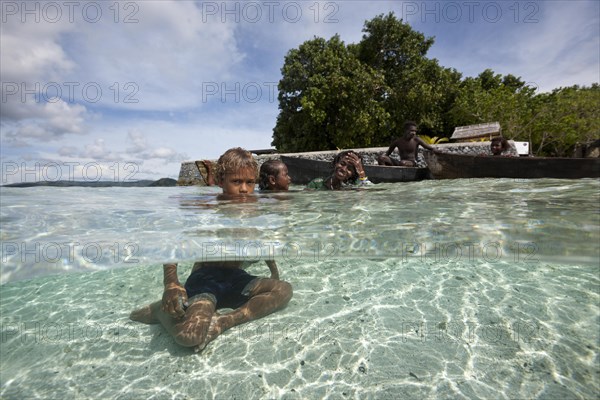 Children playing in lagoon