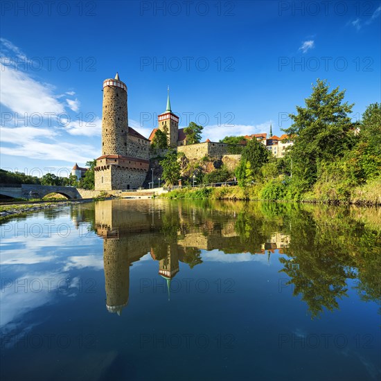 Old water art and St. Michael's church reflected in the water of the Spree