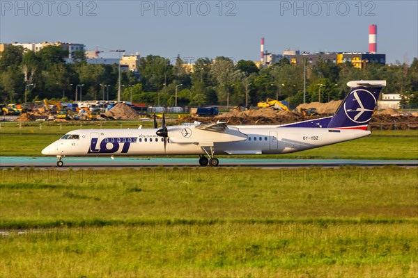 A Bombardier DHC-8-400 of LOT Polskie Linie Lotnicze with registration OY-YBZ at Warsaw Airport