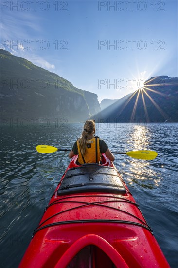 Young woman paddling in a kayak