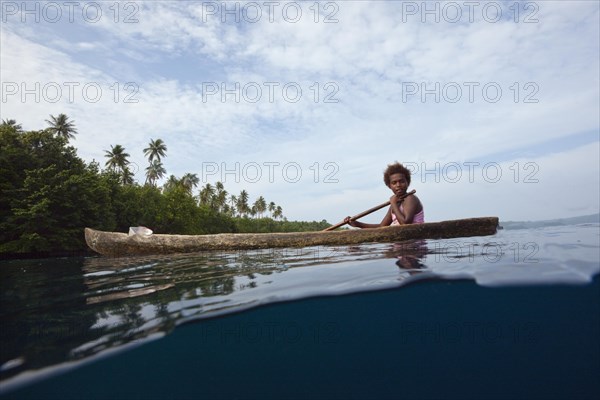 Locals in dugout canoes