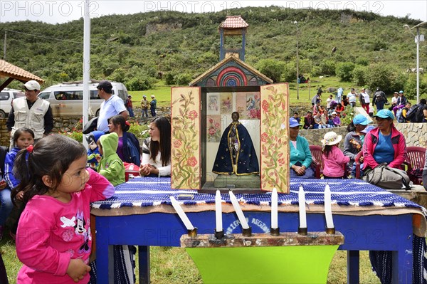 Little indigenous girl looking at a shrine during a folk festival